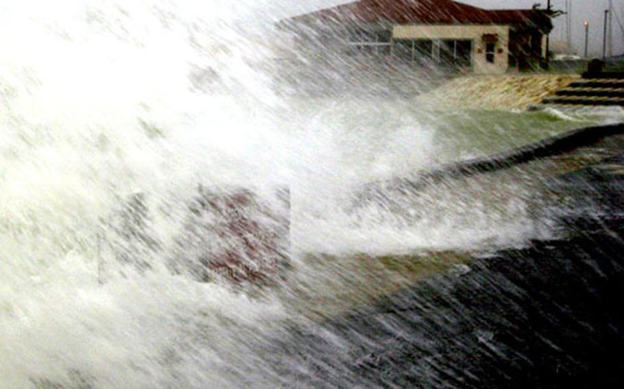 Ocean water crashes over the seawall at the Kadena Marina, as Typhoon Saomai stirs things up on Okinawa on Sept. 13, 2000.