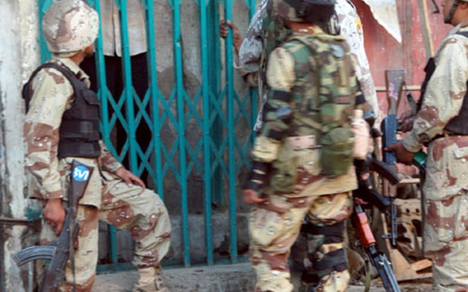 Iraqi soldiers interview a Baghdad resident during Operation Cobra Lightning. The Iraqis conducted initial interviews and the house searches while U.S. sergeants looked on.