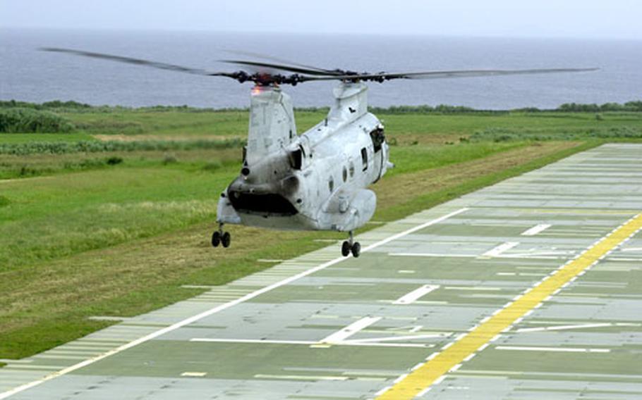 The pilot of a CH-46 is directed onto a simulated ship deck at a training area on Ie Shima island off the west coast of Okinawa on Thursday.