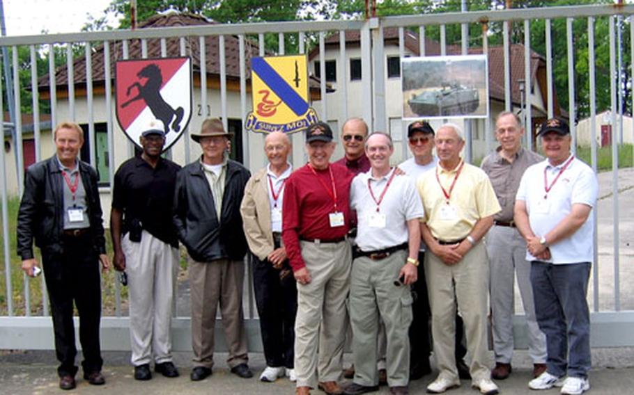 Veterans of the 11th and 14th Armored Cavalry regiments pose at the former front gate of Camp Lee along the one-time border between East and West Germany. Members of the unit, who once helped guard the border, dedicated a marker at the camp last week explaining its role in the border patrol mission.