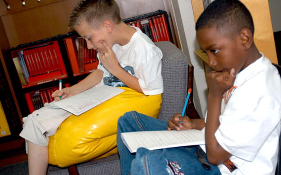 Students Art Studzianok, left, and Monquise Lesane think about a question during a book discussion about Mark Twain in Read 180 class this week.