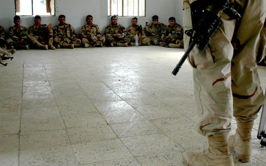 Iraqi soldiers listen to their instructor, Staff Sgt. Walter Nichols, 41, of Niagara Falls, N.Y.