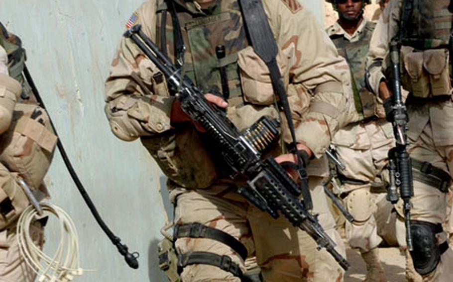 Pfc. Joseph Sternhagen charges into a house as U.S. and Iraqi soldiers searched scores of residences in Monday’s operation in Bayji, a key crossroads for transportation and oil.
