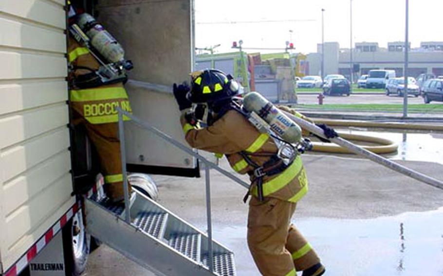 Firefighters from Naval Support Activity Naples enter their “burn trailer” during training near the Gricignano housing area fire department. The NSA Naples Fire Department was recently selected as the best in the Navy and will represent the service in the Defense Department judging Aug. 15 in Denver.