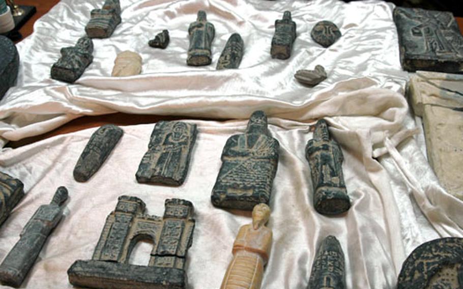 Iraqi soldiers detained an Egyptian man and confiscated 27 artifacts, right, believed to be several thousand years old and looted from an Iraqi museum during the early days of the war, according to Gen. Jaleel Khalaf Shawail, a one-star general in charge of the Iraqi 1st Brigade. On Tuesday, Aug. 3, 2021, Iraq said that the United States handed back more than 17,000 smuggled artifacts confiscated by U.S. authorities.