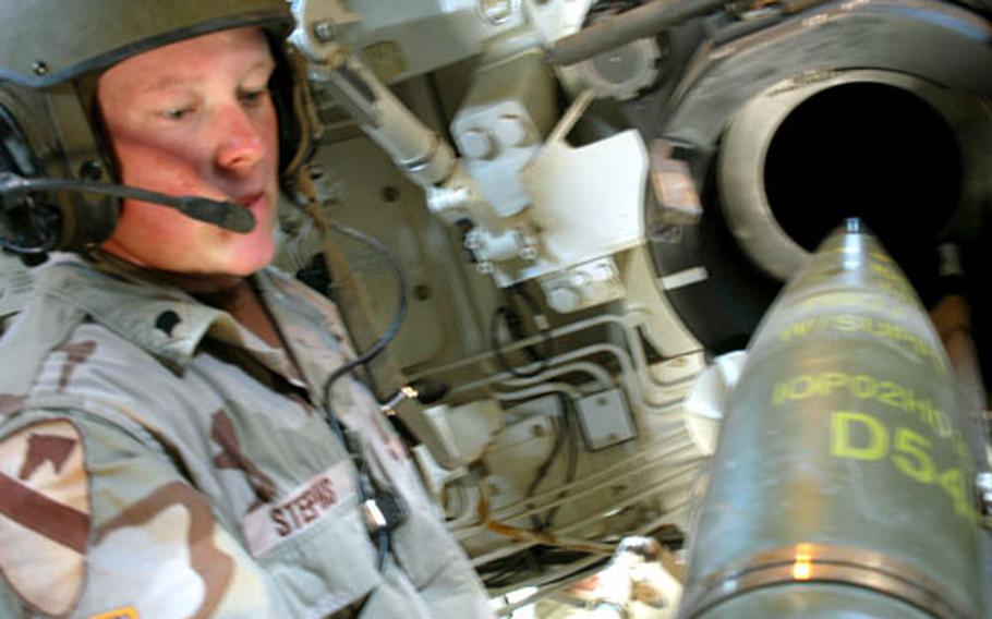 Spc. David Stephens, 21, of Miskeego, Wis., loads ammunition into the barrel of a M109 Alpha 6 Howitzer during a qualification test Friday at Camp Tigerland in Baghdad. Each chief of each four-man crew must qualify every six months in order to operate the gun. Stephens is the “No. 1 man,” the soldier responsible for loading the weapon.