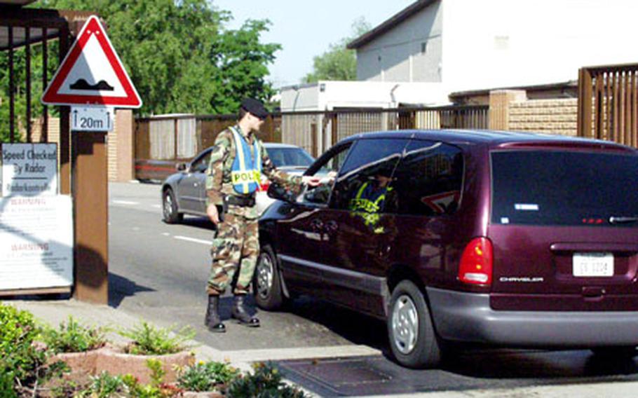 Senior Airman Jonathon Johnson with the 569th U.S. Forces Police Service checks an ID card Wednesday at the entrance to the Air Force’s Vogelweh installation in Kaiserslautern, Germany. The Vogelweh gate will be closed on June 20 for about eight weeks.