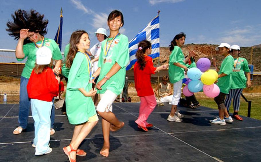 Athletes, volunteer coaches and spectators dance after the awards ceremony at the annual Special Olympics event at Naval Support Activity Souda Bay, Crete.