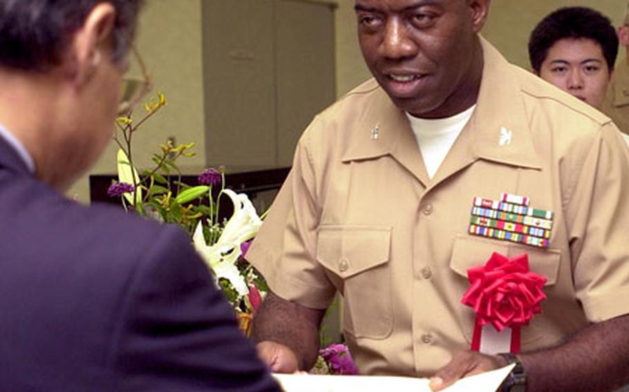 Marine Col. Doarin Lewis, commander of 3rd Transportation Support Battalion, receives a good conduct certificate from the Okinawa Chapter of the Japan Good Conduct Association for the actions of his unit.