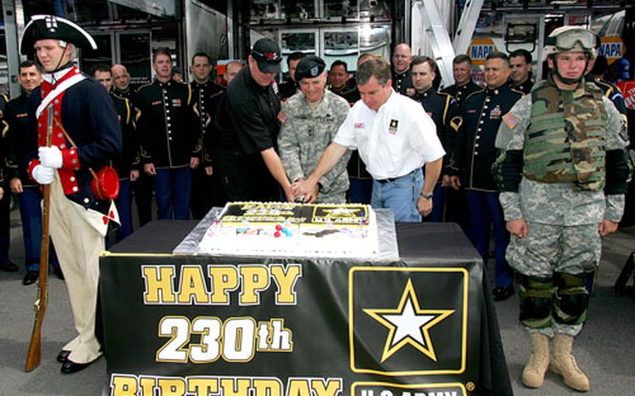 Maj. Gen. Alan W. Thrasher, center; Jay Frye, left, general manager for MB2 Motorsports; and NASCAR driver Joe Nemechek use a sword to cut a cake celebrating the 230th birthday of the U.S. Army. Nemechek, driver of the No. 01 Army-sponsored Chevrolet, sported a special Army paint scheme for Sunday’s running of the Pocono 500 at Pocono Raceway in Long Pond, Pa.