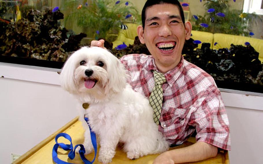 Moritsugi Yonaha and Sophie share smiles during a therapy dog visit at the Okinawa Children Development Center in Okinawa City. Sophie is one of the four therapy dogs from the U.S. military community who visit the center's residents every Saturday.