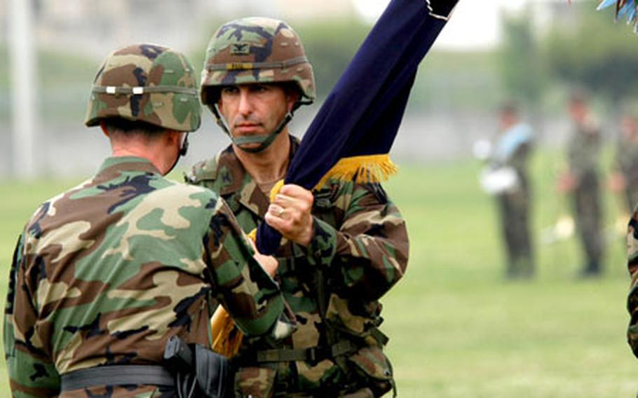 Col. Michael Feil accepts the unit’s colors, officially activating the unit at Camp Casey.