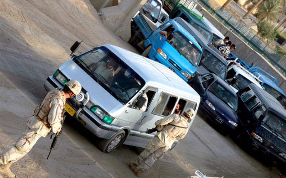 Soldiers working Gate 4 begin to wave through individual trucks from a line of dozens waiting to get into Camp Liberty on Tuesday morning. The security checks at Gate 4, one of only two civilian access points to the mammoth base in Baghdad, have several stages, including questioning, X-ray and imaging monitors, dogs sniffing for explosives and hand searches.