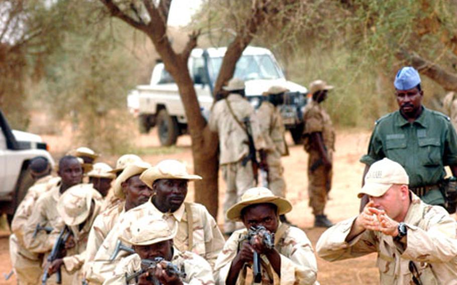 A Green Beret staff sergeant, right, from 1st Battalion, 10th Special Forces Group, teaches foot-patrol tactics on Tuesday to soldiers in Tahoua, Niger. The training is part of Flintlock ’05, an exercise to train armies in several African countries and build U.S.-African relations.