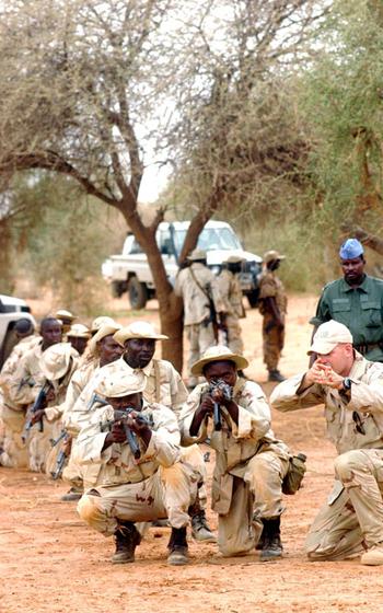 A Green Beret staff sergeant, right, from 1st Battalion, 10th Special Forces Group, teaches foot-patrol tactics on Tuesday to soldiers in Tahoua, Niger. The training is part of Flintlock ’05, an exercise to train armies in several African countries and build U.S.-African relations.
