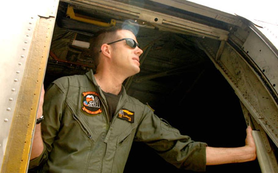Petty Officer 1st Class Ron Clements, a C-130 loadmaster from VR-64, looks out from his aircraft Tuesday at Atsugi.