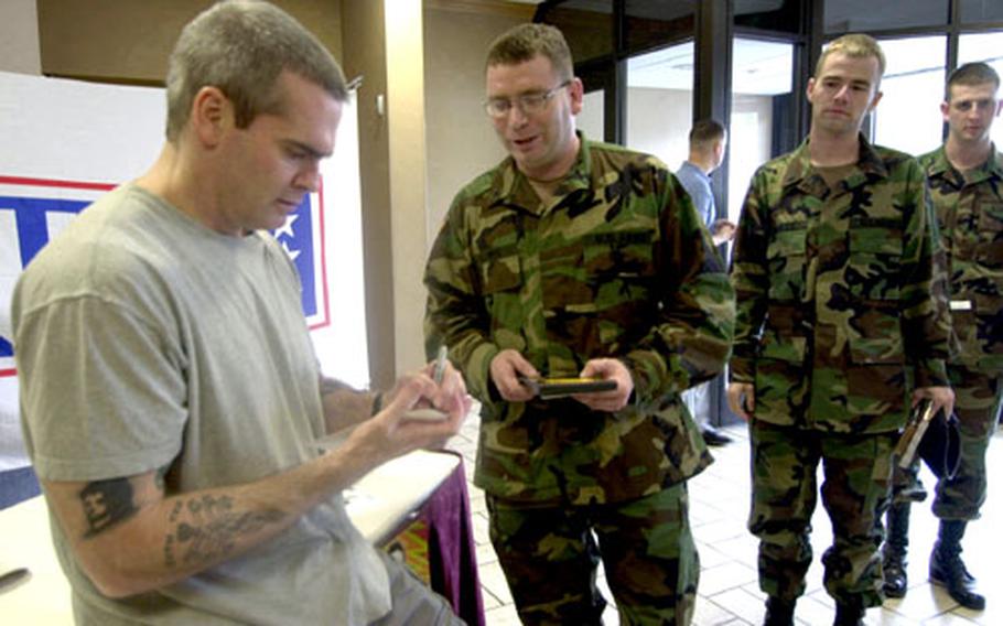 Henry Rollins signs an autograph for Spc. Ed Palmer on Wednesday at the Main Post Club on Yongsan Garrison, South Korea.