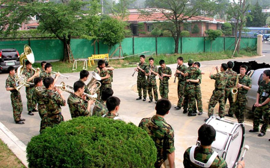 A South Korean air force band plays “Auld Lang Syne” at a farewell ceremony for two fellow members on the last day of their military service last week at Osan Air Base, South Korea.