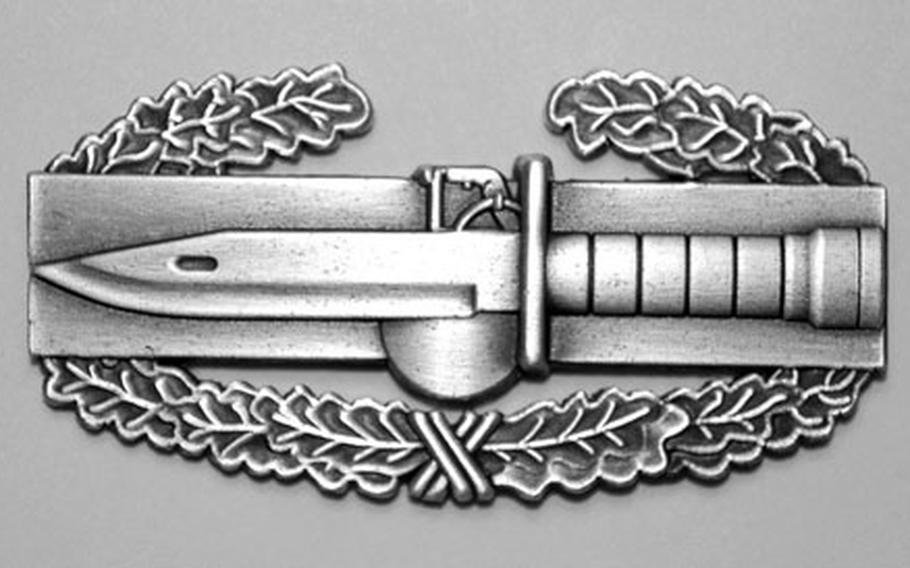 The new Cambat Action Badge badge has a rectangular design and encircling laurel wreath that echoes its inspiration, the Combat Infantry Badge.