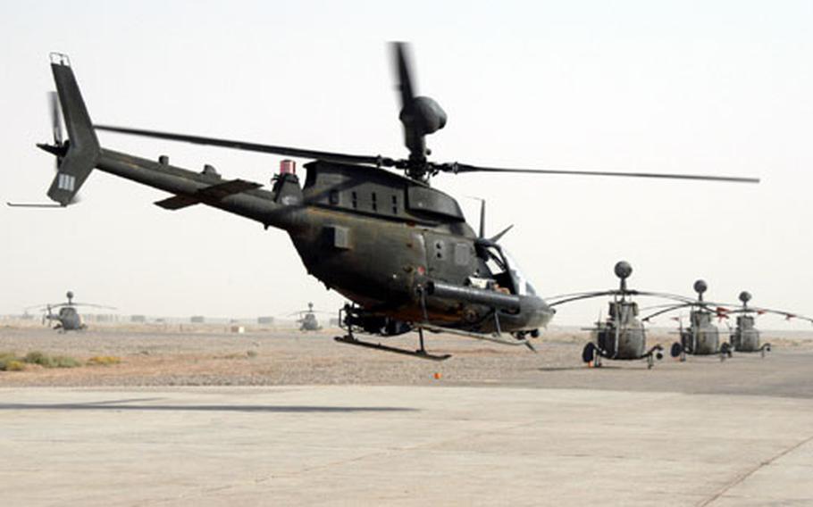 A Kiowa Warrior takes off from FOB McKenzie in central Iraq Tuesday morning, despite a growing dust storm. The pilots at McKenzie, who are with the 1st Squadron of the 17th Calvary of the 82nd Airborne, contend with hazy, sand-filled air that has canceled some missions.