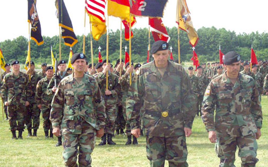 Maj. Gen. Kenneth Hunzeker, center, the new 1st Infantry Division commander, marches in front of a color guard drawn from the division’s 2nd Brigade during a brigade-level change-of-command ceremony Tuesday in Schweinfurt, Germany. Hunzeker is flanked by Col. Randy Dragon, left, who is the outgoing brigade commander, and Col. J.B. Burton, the new commander.