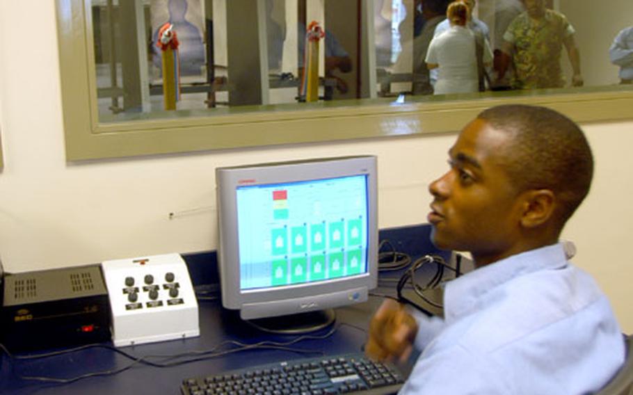 Range safety observer Petty Officer 2nd Class LaMarcus Hopsen sits in front of Naval Air Station Sigonella’s range safety computer at the base’s new firing range, which opened Monday. With the computer, Hopsen can control safety devices, lighting and each of the 10 targets.
