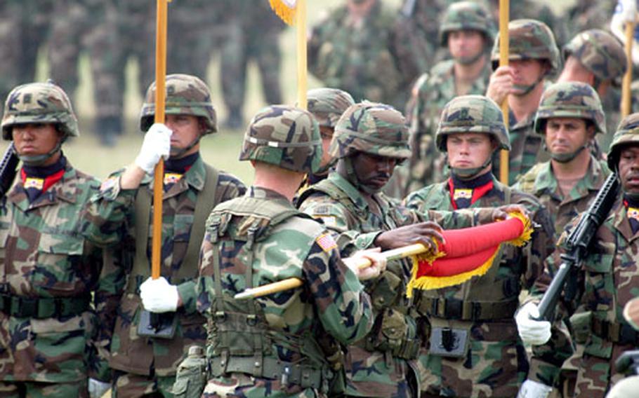 The 2nd Infantry Division Support Command colors are cased at Camp Casey, South Korea, on Friday during an inactivation ceremony.