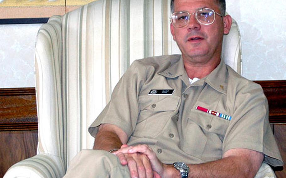 Capt. Jessie Tate, chaplain for Commander U.S. Naval Installations, relaxes in his room at Sasebo Naval Base’s Bachelor Officers Housing. His stay is part of a tour visiting Navy religious ministries personnel in the Pacific. Tate’s visits also included Singapore, Yokosuka Naval Base and Atsugi Naval Air Facility. He heads to South Korea next.