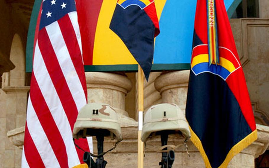 The empty boots, dog tags, inverted rifles and helmets of Army National Guard Capt. Phillip T. Esposito , Esposito and First Lt. Louis E. Allen comprise a memorial on display in Tikrit, Iraq.