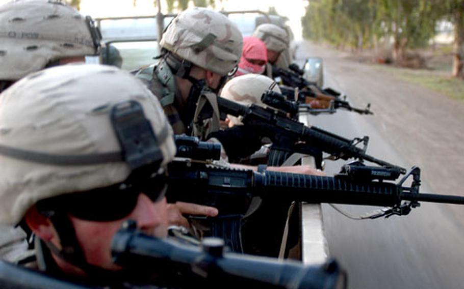 Iraqi soldiers are instructed by U.S. forces as they drive near Hawijah, Iraq.