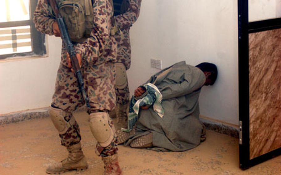 Iraqi security forces capture a fake insurgent, part of a commando course taught by U.S. Special Forces.