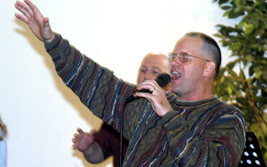 Lt. Col. Howard Malone, emergency services director of the 104th Area Support Group, leads a church band at Fliegerhorst Chapel on a recent Sunday.