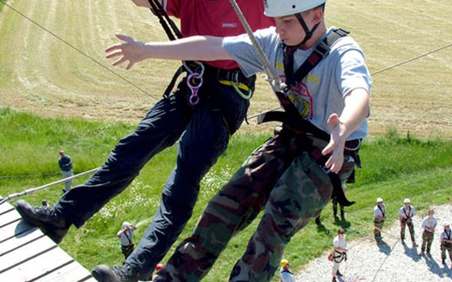 Mannheim High School student Adam Hockenjos gets some tips on making a smooth descent from a high platform.