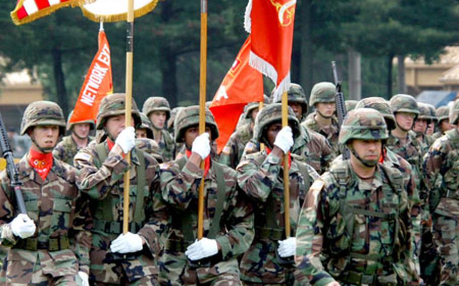 122nd Signal Battalion soldiers parade with their colors for the last time during an inactivation ceremony at Camp Red Cloud on Tuesday.