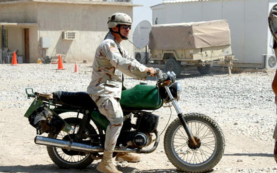 Sgt. John Broderick, 40, of Chicago, rides his German MZ, a motorcycle he picked up a few weeks ago at Camp Normandy. Broderick fixed the bike for its owners there, and they let him have it as payment. Now he rides around FOB Gabe, near Baqubah.