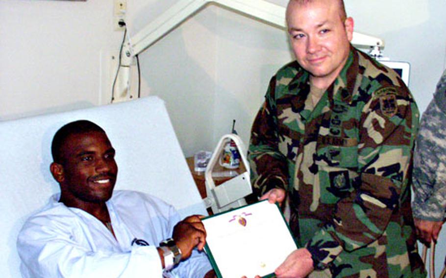 Sgt. Travis Stoddard, seen when he received his Purple Heart, said he liked what he read of “The Long Road Home” during his recovery at Landstuhl. “That book is all right,” said the 25-year-old from Greenville, S.C.