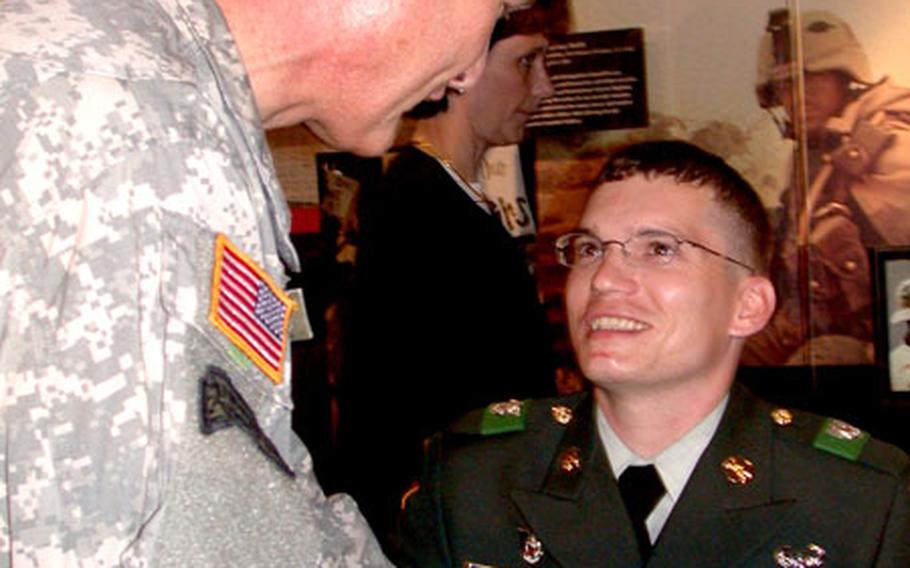 Army Lt. Gen. David Barno, the Army’s assistant chief of staff for Installation Management, congratulates Army Sgt. Michael Buyas, one of the first five soldiers to receive the new Combat Action Badge on Wednesday at the Pentagon.