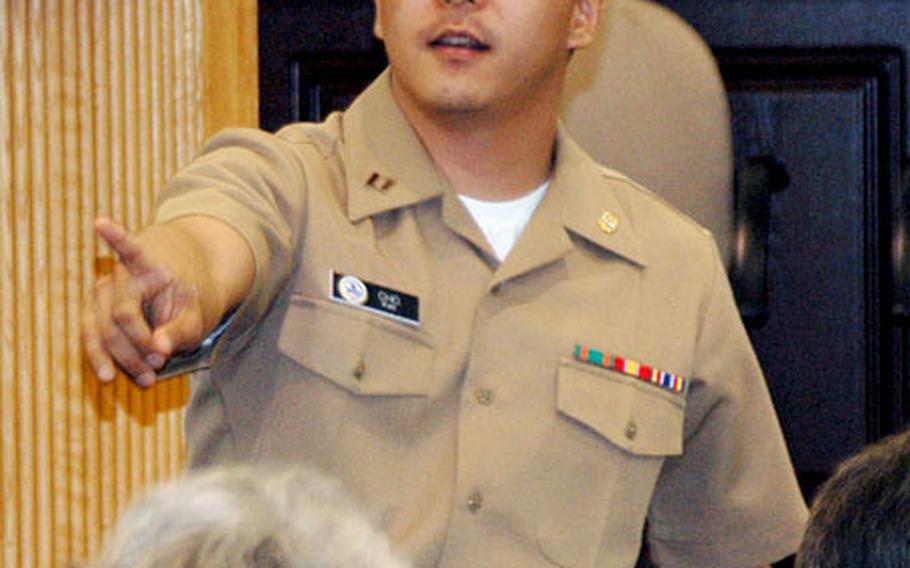Lt. Albert Cho, an attorney from the Navy Legal Services Office, answers questions about services offered by his department at a town hall meeting Tuesday night at Sasebo Naval Base, Japan’s Community and Education Center.