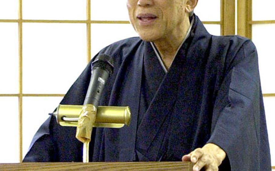 SEN Genshitsu, former grand master of the Urasenke tradition of the Way of Tea, talks to sailors and Marines at Camp Shields, Okinawa, on Monday.