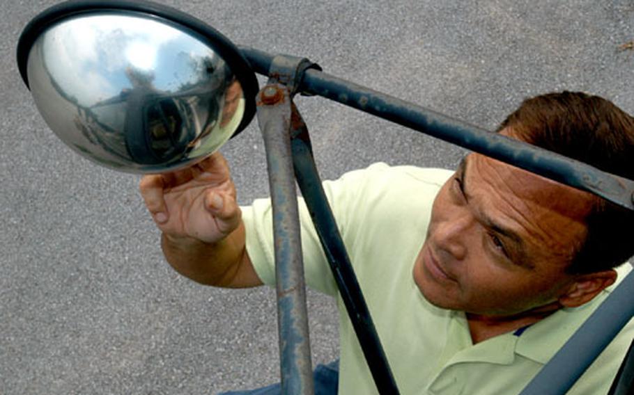 Second Infantry Division safety officer Denver McClintock inspects one of the new mirrors that all large 2nd ID vehicles must have so that drivers can see pedestrians walking below. The mirrors are part of a group of safety measures implemented after a U.S. military vehicle struck and killed a South Korean woman last month.
