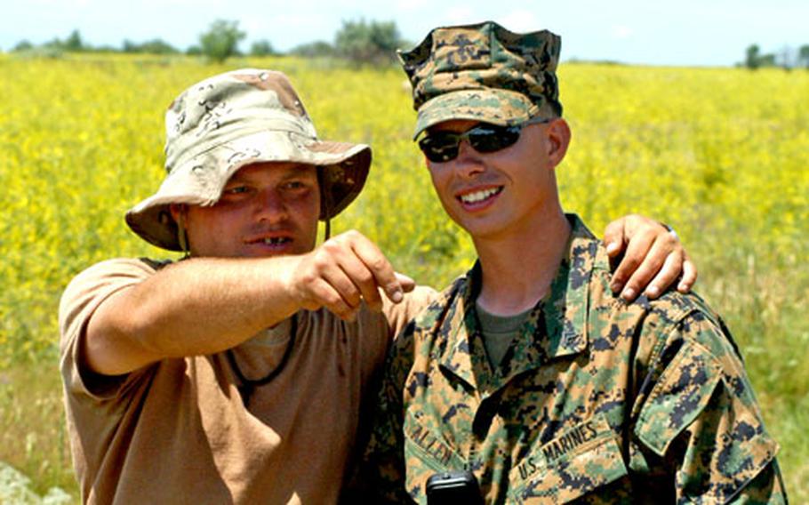 U.S. Marine Cpl. Justin Allen talks with a Georgian soldier during a break Tuesday during a training exercise outside of Tbilisi, Georgia. Allen has learned enough Georgian to speak simple sentences and has acquired a nickname among the members of the platoon he oversees.