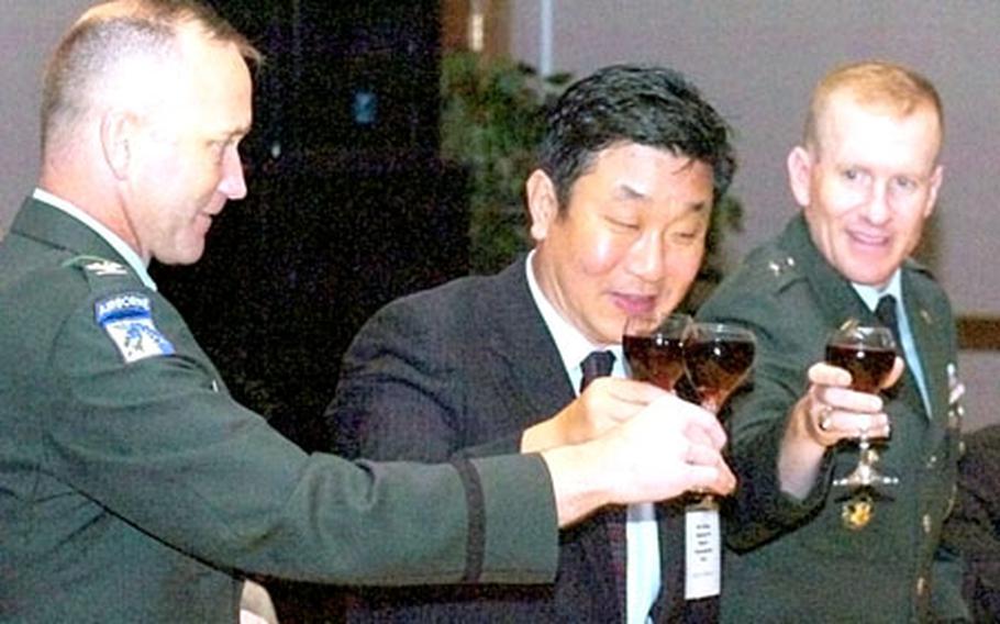 At Camp Humphreys in South Korea last month, U.S. Army officials are joined by Pyongtaek City mayor Song Myong-ho in toasting recipients of Good Neighbor Awards during a dinner in the awardees’ honor. At left is Col. Michael J. Taliento Jr., Area III Support Activity commander; at right is Brig. Gen. Steven M. Anderson, deputy commander, USFK.