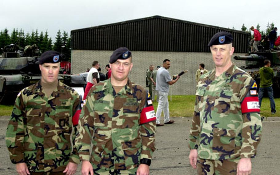 Three of Baumholder’s four-man range control detachment posed during an open house for the 50th Anniversary of the founding of the post-war Germany army, or Bundeswehr. From left are Staff Sgt. David Pierce, Sgt. Jens Fisk and Sgt. 1st Class Steven Nimocks.