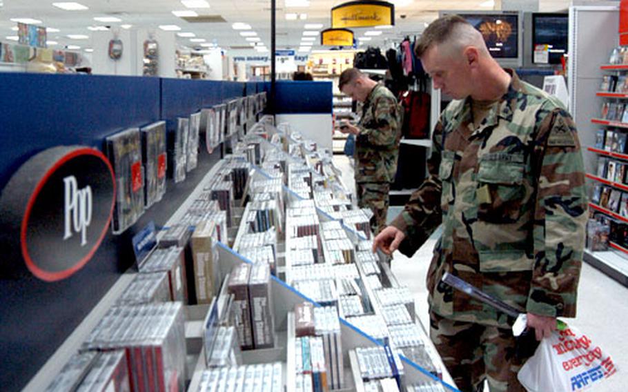Spc. Michael McRae, right, and Sgt. Eric Nagy, both of the BŸdingen, Germany-based 1st Squadron, 1st Armored Cavalry Regiment, check out the CD selection at the Hanau Army and Air Force Exchange Service post exchange.