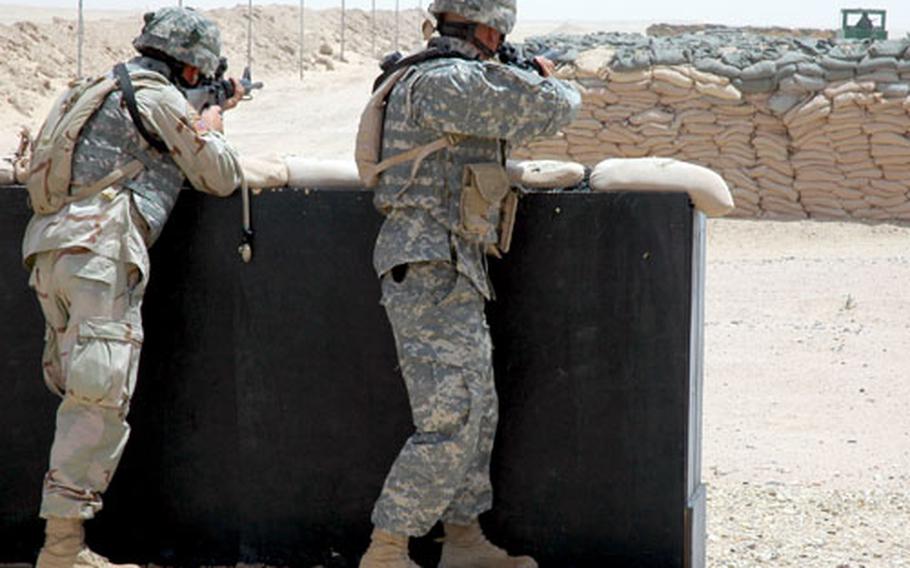 Members of the 2nd Battalion of the 222nd Field Artillery Regiment of the Utah National Guard take aim at a moving “enemy” target at the Udairi Range, Kuwait. The unit is one of several completing a series of exercises this week to sharpen the soldiers’ skills in marksmanship, operating road blocks and traveling in convoys before heading to Iraq.