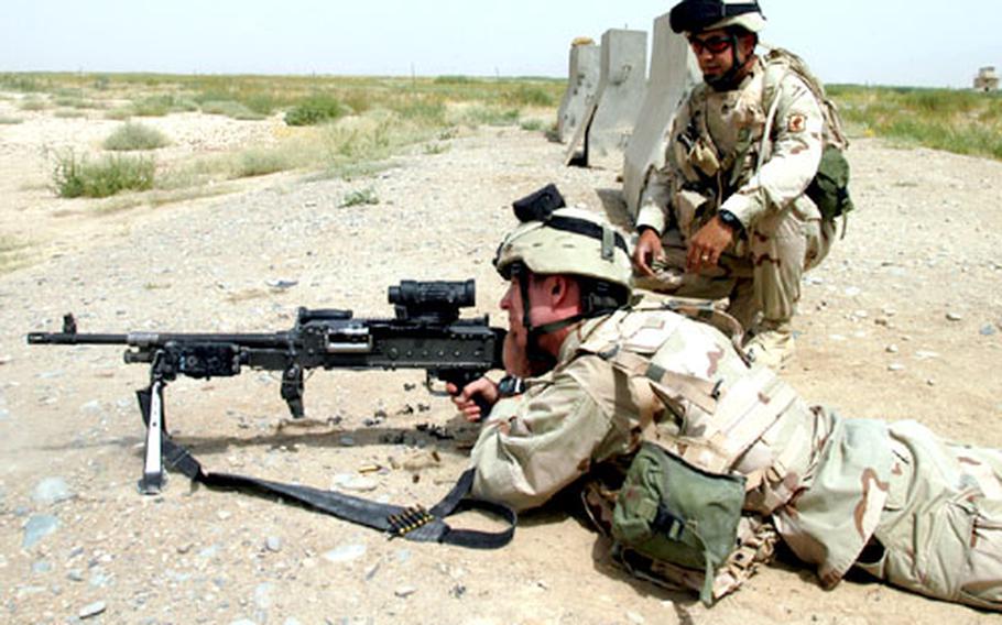 Staff Sgt. Carlos Navas watches as Spc. Mike Lehmiller fires an M-240B machine gun Thursday at the Kandahar Airfield range in Afghanistan. Soldiers from 3rd Platoon, Company B, 2nd Battalion, 503rd Parachute Infantry Regiment spent Thursday training on a variety of weapons.