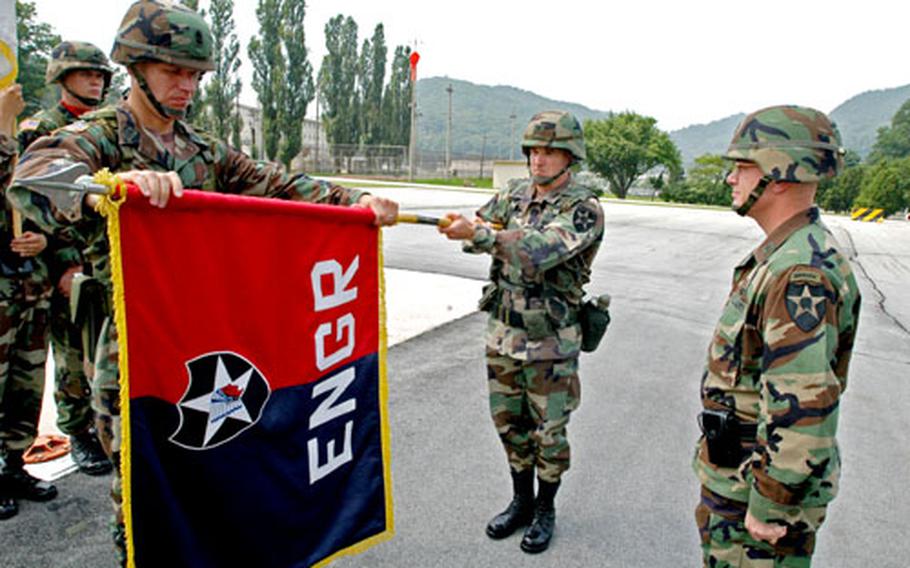 From left, Sgt. Maj. Herbert Mason, Engineer Brigade Commander Col. Rock Donahue and Brig. Gen. Joseph E. Martz, 2nd Infantry Division assistant division commander (maneuver), case the Engineer Brigade colors at Camp Casey, South Korea, on Friday.