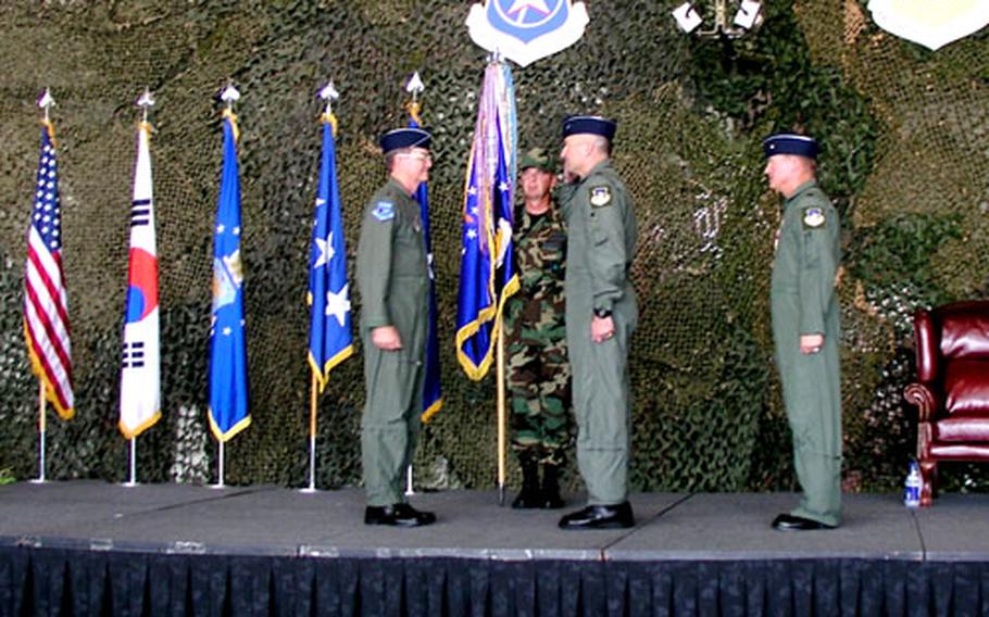 Brig. Gen. Joseph Reynes Jr., center, salutes 7th Air Force commander Lt. Gen. Garry R. Trexler during a ceremony Friday at Osan Air Base, South Korea, at which Reynes assumed command of the 51st Fighter Wing. Reynes replaces Brig. Gen. Maurice H. Forsyth, right.