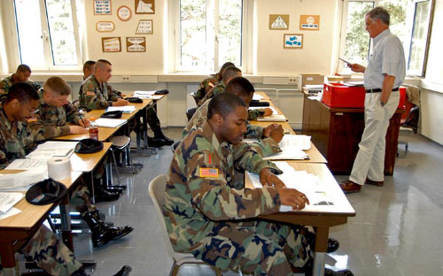 Students go over a quiz with instructor Steve Laxton on Friday in a Functional Academic Skills Training course at the Army education center on Warner Barracks in Bamberg, Germany. The course is designed to help students improve their test scores.