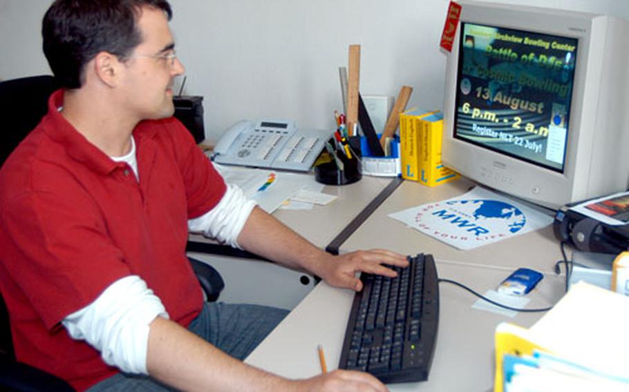 Simon Hupfer, marketing specialist for Morale, Welfare and Recreation at the 279th Base Support Battalion, scans through slides shown on the Command Information Channel on Friday.